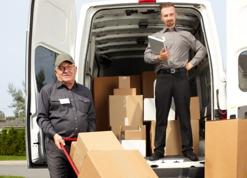Large furniture being secured inside a moving van