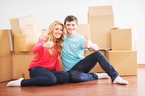 A professional moving crew working safely with protected furniture and boxes