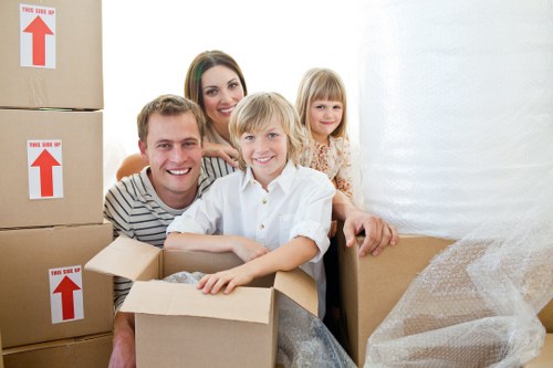 Moving team handling boxes and furniture during removals in Belsizepark
