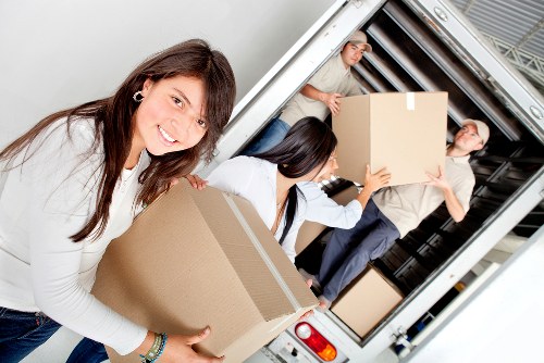 Team managing furniture removals in Belsize Park inside a home